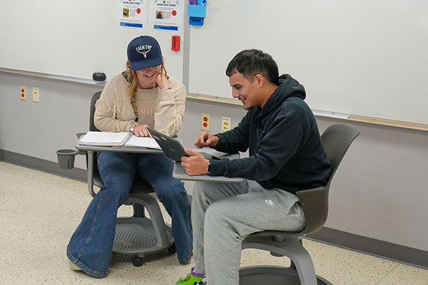 Two students studying at the Uvalde Campus Student Success Center.