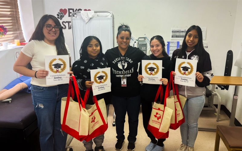 La Pryor ISD PCT students pose alongside their instructor with certificates and SWTX tote bags.