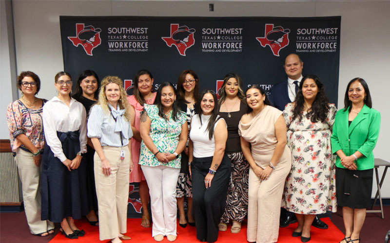 Mental Health Technician graduates pose in front of an SWTX logo background alongside Rossina Salas, Keynote Speaker Jaclyn J. Gonzales, and Workforce Training & Development staff at the August 2026 ceremony.