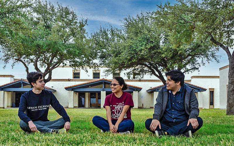 Students visit at a courtyard on the Eagle Pass campus.